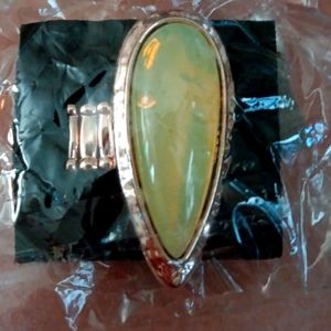 Gold tone stretch index finger ring with a large opal teardrop shaped center.